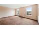 Bedroom with neutral paint and carpeting, featuring two windows for natural light at 11098 Fairfax Way, Thornton, CO 80233