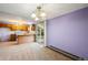 Dining room with light purple walls and sliding glass door to backyard deck at 11098 Fairfax Way, Thornton, CO 80233