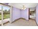Dining room with purple accent wall and sliding glass door leading to outdoor deck at 11098 Fairfax Way, Thornton, CO 80233