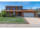 Two story home featuring a well-manicured lawn, brick accents, and an attached two-car garage at 11098 Fairfax Way, Thornton, CO 80233