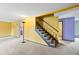 Spacious living room with carpet, yellow walls, and a staircase leading to the upper level at 11098 Fairfax Way, Thornton, CO 80233