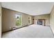 Spacious living room with fireplace and natural light from two large windows at 11098 Fairfax Way, Thornton, CO 80233