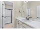 Updated bathroom offers vanity with sink and shower with black sliding door at 49 Willowcroft Dr, Littleton, CO 80123