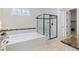 Modern bathroom with soaking tub, glass shower, and designer tile accents at 49 Willowcroft Dr, Littleton, CO 80123