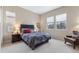 Comfortable bedroom with a large bed, lots of light, and comfortable chair at 49 Willowcroft Dr, Littleton, CO 80123