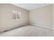 Bright bedroom with neutral carpet, egress window, and ample space for furnishings at 49 Willowcroft Dr, Littleton, CO 80123