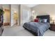 Comfortable bedroom with a large bed and a closet in a neutral color palette and an ensuite bathroom at 49 Willowcroft Dr, Littleton, CO 80123