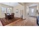 Formal dining room with dark wood table and shutters on the windows viewed from the hallway at 49 Willowcroft Dr, Littleton, CO 80123