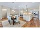 Open-concept living area with a dining room table and a view to the open kitchen at 49 Willowcroft Dr, Littleton, CO 80123