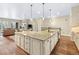 Spacious open kitchen featuring a large island with granite countertops and modern lighting at 49 Willowcroft Dr, Littleton, CO 80123