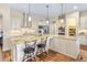 Modern kitchen featuring a granite island with seating, stainless appliances, and custom cabinetry at 49 Willowcroft Dr, Littleton, CO 80123