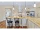 Modern kitchen featuring a granite island with seating, stainless appliances, and custom cabinetry at 49 Willowcroft Dr, Littleton, CO 80123