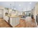 Bright and airy kitchen features an island, stainless steel appliances, and light wood floors at 49 Willowcroft Dr, Littleton, CO 80123