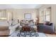Inviting living room with neutral tones, plush sofas, and a patterned area rug at 49 Willowcroft Dr, Littleton, CO 80123