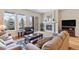 Cozy living room with a fireplace, large windows, and comfortable seating, perfect for relaxation at 49 Willowcroft Dr, Littleton, CO 80123