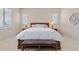 Bright main bedroom featuring shuttered windows, wood furniture, and a plush bed at 49 Willowcroft Dr, Littleton, CO 80123