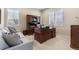 Cozy office space with a wooden desk, shelves, and a comfortable gray couch with patterned pillows at 49 Willowcroft Dr, Littleton, CO 80123
