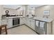 Modern wet bar showcases stainless steel appliances, granite countertops, and tile flooring at 49 Willowcroft Dr, Littleton, CO 80123