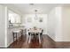 Dining room features modern table, kitchen bar with stools, and light hardwood floors at 7205 S Gaylord St # F15, Littleton, CO 80122
