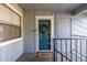 A blue front door with wreath is shown in a well-lit landing at 7205 S Gaylord St # F15, Littleton, CO 80122