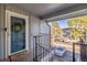Front door entryway and covered porch with welcome mat in a multi-unit residence at 7205 S Gaylord St # F15, Littleton, CO 80122