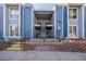 Front exterior view of a blue multi-unit complex with reserved parking and accessible entry at 7205 S Gaylord St # F15, Littleton, CO 80122
