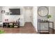 Hallway entrance featuring a modern entertainment console, a decorative table and hardwood floors at 7205 S Gaylord St # F15, Littleton, CO 80122