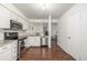 Bright kitchen features stainless steel appliances, white cabinets, and granite countertops at 7205 S Gaylord St # F15, Littleton, CO 80122