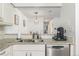 Close-up of kitchen counter with stainless steel sink, dishwasher, and modern coffee maker at 7205 S Gaylord St # F15, Littleton, CO 80122