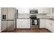 Modern kitchen with stainless steel appliances, granite countertops, and white cabinets at 7205 S Gaylord St # F15, Littleton, CO 80122