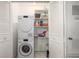 Well-organized laundry room with stacked washer and dryer and shelving at 7205 S Gaylord St # F15, Littleton, CO 80122
