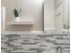 Charming bathroom featuring modern grey and white tile work, with a floating shelf and a green plant at 1130 N N Pennsylvania St # 306, Denver, CO 80203