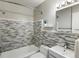 Bright bathroom features updated vanity, mirror, and tiled shower at 1130 N N Pennsylvania St # 306, Denver, CO 80203