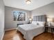 Well-lit bedroom features large window, hardwood floors, and modern furnishings at 1130 N N Pennsylvania St # 306, Denver, CO 80203