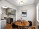 Cozy dining area with wood table, gray cabinets, and modern backsplash at 1130 N N Pennsylvania St # 306, Denver, CO 80203