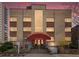 Brick apartment building at 1130 Penn with covered entry and colorful sunset at 1130 N N Pennsylvania St # 306, Denver, CO 80203