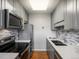This updated kitchen features stainless steel appliances and a mosaic backsplash at 1130 N N Pennsylvania St # 306, Denver, CO 80203