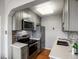 Updated kitchen features stainless steel appliances, grey cabinets, and modern backsplash at 1130 N N Pennsylvania St # 306, Denver, CO 80203