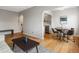 Inviting living room with hardwood floors, open layout to kitchen, and dining area at 1130 N N Pennsylvania St # 306, Denver, CO 80203