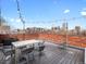 City views from the open roof deck with brick surround and seating area, perfect for outdoor gatherings at 1130 N N Pennsylvania St # 306, Denver, CO 80203