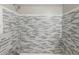 Stylish shower featuring modern grey and white horizontal tile work from floor to ceiling at 1130 N N Pennsylvania St # 306, Denver, CO 80203