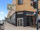 A street view captures the exterior of City O' City, showcasing its glass garage door-style windows at 1130 N N Pennsylvania St # 306, Denver, CO 80203