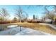 Expansive backyard with mature trees, a patio area, and ample space for outdoor activities and gardening at 7248 S Broadway, Centennial, CO 80122