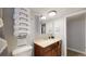 Remodeled bathroom with a wood vanity and shower, offering a fresh feel at 7248 S Broadway, Centennial, CO 80122