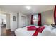 Bright bedroom with hardwood floors, comfortable bed with stylish linens, and a closet at 7248 S Broadway, Centennial, CO 80122