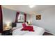 Bright bedroom with hardwood floors, comfortable bed with stylish linens, and stylish nightstands at 7248 S Broadway, Centennial, CO 80122