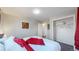 Bright bedroom with hardwood floors, comfortable bed with stylish linens, closet space and doorway at 7248 S Broadway, Centennial, CO 80122