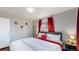 Bedroom with red accents and wood floors featuring decor and natural light at 7248 S Broadway, Centennial, CO 80122