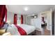 Bedroom featuring a television, closet, and view into an adjacent bedroom at 7248 S Broadway, Centennial, CO 80122