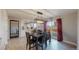 The dining area has a wood table with seating for six, stylish pendant lighting, and sliding glass doors to outside at 7248 S Broadway, Centennial, CO 80122
